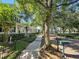 A sidewalk runs along a tree-lined street with neat landscaping and mailboxes in front of beautiful homes at 821 Veranda Pl, Celebration, FL 34747