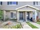 Tan two-story townhome with 2 front doors, landscaping, and walkway at 113 Kristi Ann Ct # 113, Winter Springs, FL 32708