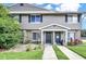 Tan two-story townhome with 2 front doors, landscaping, and walkway at 113 Kristi Ann Ct # 113, Winter Springs, FL 32708