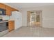 Galley kitchen with wood cabinets, stainless steel appliances, and tiled floor at 113 Kristi Ann Ct # 113, Winter Springs, FL 32708