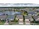 Aerial view of houses near a lake with green lawns at 17833 Blazing Star Cir, Clermont, FL 34714