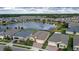 Aerial view of houses near a lake with green lawns at 17833 Blazing Star Cir, Clermont, FL 34714