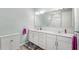 Bright bathroom boasts double vanity, large mirror, and shower at 17833 Blazing Star Cir, Clermont, FL 34714