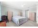Primary bedroom with a large bed and wooden armoires at 17833 Blazing Star Cir, Clermont, FL 34714