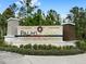 Stone entrance sign welcomes residents to Palms at Serenioa community at 17833 Blazing Star Cir, Clermont, FL 34714