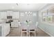 Dining area with white table and chairs near the kitchen at 17833 Blazing Star Cir, Clermont, FL 34714