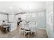 Bright dining area with white table and chairs, and an island at 17833 Blazing Star Cir, Clermont, FL 34714