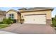 Brick paver driveway and two-car garage, well-maintained landscaping at 17833 Blazing Star Cir, Clermont, FL 34714