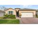 Single-story home with a two-car garage and landscaped front yard at 17833 Blazing Star Cir, Clermont, FL 34714