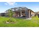 Home exterior showcasing a large screened patio and lush lawn at 17833 Blazing Star Cir, Clermont, FL 34714