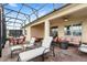 Relaxing screened patio with seating area and fire pit at 17833 Blazing Star Cir, Clermont, FL 34714
