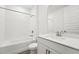 Clean bathroom featuring a shower-tub combo, white tile, and a vanity with a white quartz countertop at 2316 Citrus Bloom Dr, Bartow, FL 33830