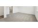 This bedroom features neutral paint and carpet and an open doorway at 2316 Citrus Bloom Dr, Bartow, FL 33830