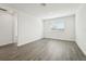 Well-lit bedroom with modern gray tile floor, white walls and a large window with backyard views at 2316 Citrus Bloom Dr, Bartow, FL 33830