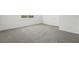 Bright bedroom with neutral carpet and white trim, featuring a large window for natural light at 2316 Citrus Bloom Dr, Bartow, FL 33830