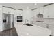 Bright kitchen featuring stainless steel appliances, white shaker cabinets, quartz countertops, and modern fixtures at 2316 Citrus Bloom Dr, Bartow, FL 33830