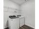 This laundry room features wood-look tile and newer washer and dryer at 2316 Citrus Bloom Dr, Bartow, FL 33830