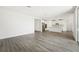 Open-concept living room showcasing the modern kitchen and sleek wood-look tile flooring throughout at 2316 Citrus Bloom Dr, Bartow, FL 33830