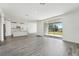 Inviting living area with an open layout featuring a modern kitchen, large windows, and stylish flooring at 2316 Citrus Bloom Dr, Bartow, FL 33830