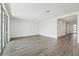 Spacious living room with sleek wood-look tile flooring and ample natural light from sliding glass doors at 2316 Citrus Bloom Dr, Bartow, FL 33830