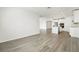 Open-concept living space featuring stylish wood-look tiling and a bright, airy atmosphere flowing into the kitchen at 2316 Citrus Bloom Dr, Bartow, FL 33830