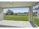 Covered patio overlooking a lush green lawn and natural landscape, offering a serene outdoor space at 2316 Citrus Bloom Dr, Bartow, FL 33830