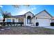 Attractive single-story home with a two-car garage and well-manicured lawn at 2485 Huron Cir, Kissimmee, FL 34746