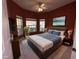 This primary bedroom features neutral walls, a ceiling fan, and large windows at 2485 Huron Cir, Kissimmee, FL 34746