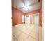 A bedroom with peach walls, tile floors, and double closets at 2485 Huron Cir, Kissimmee, FL 34746