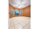 Bedroom with orange walls, tile floors, and a large window at 2485 Huron Cir, Kissimmee, FL 34746