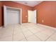 Bedroom with orange walls, tile floors, and a closet at 2485 Huron Cir, Kissimmee, FL 34746