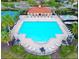 Large community pool with ample seating, lush landscaping, and a tennis court at 2485 Huron Cir, Kissimmee, FL 34746
