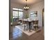 Elegant dining room with modern chandelier, plush rug, and ample natural light at 2485 Huron Cir, Kissimmee, FL 34746