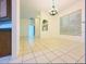 Open dining area with tiled flooring, a decorative chandelier, and plenty of natural light at 2485 Huron Cir, Kissimmee, FL 34746