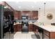 Modern kitchen with dark cabinets, black appliances, and an island at 269 Primrose Dr, Davenport, FL 33837