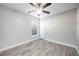 Spacious bedroom with wood-look floors and ceiling fan at 3625 Lone Pine Dr, Orlando, FL 32822