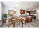 Kitchen and dining area with a large wooden table and modern pendant lights at 3625 Lone Pine Dr, Orlando, FL 32822