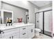 Bathroom featuring a double sink vanity with modern fixtures and a glass-enclosed shower at 406 Nw Narcissus Rd, Dunnellon, FL 34431