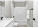 Bathroom with a single sink vanity, granite countertops, and a tiled shower and bath tub at 406 Nw Narcissus Rd, Dunnellon, FL 34431