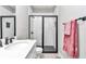 Bathroom featuring a tiled walk-in shower with modern fixtures and decorative pink towels at 406 Nw Narcissus Rd, Dunnellon, FL 34431
