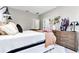 Bright bedroom with a decorative bed, stylish pillows, and a wooden dresser at 406 Nw Narcissus Rd, Dunnellon, FL 34431