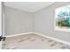 This bedroom has grey walls and a window overlooking the outdoor landscape at 406 Nw Narcissus Rd, Dunnellon, FL 34431