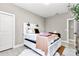 Bright bedroom with a decorative bed, stylish pillows, and views of the outdoors at 406 Nw Narcissus Rd, Dunnellon, FL 34431