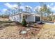 Charming single-story home featuring a two-car garage, well-manicured lawn and modern exterior design at 406 Nw Narcissus Rd, Dunnellon, FL 34431
