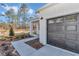 Modern home with a two-car garage, sidewalk entrance, stylish number signage, and attractive yard landscaping at 406 Nw Narcissus Rd, Dunnellon, FL 34431