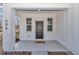 Welcoming front porch with stylish details including a cute doormat, bright windows and modern columns at 406 Nw Narcissus Rd, Dunnellon, FL 34431