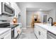 Bright kitchen featuring quartz countertops, stainless steel appliances, and ample storage at 406 Nw Narcissus Rd, Dunnellon, FL 34431