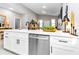Modern kitchen features a central island with a sink, sleek appliances, and decor at 406 Nw Narcissus Rd, Dunnellon, FL 34431