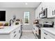 Well-lit kitchen featuring white cabinetry, modern appliances, and stylish decor for a welcoming atmosphere at 406 Nw Narcissus Rd, Dunnellon, FL 34431