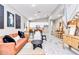 Bright living room featuring modern décor, contemporary furnishings, and an open layout leading to the kitchen at 406 Nw Narcissus Rd, Dunnellon, FL 34431